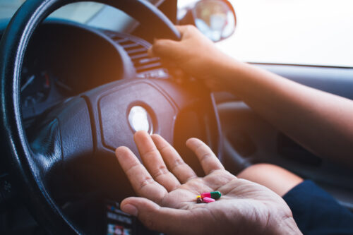 person taking drugs while driving