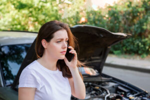 woman on phone car disabled accident