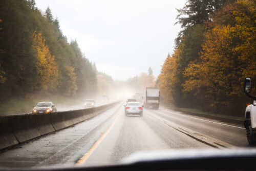 fall car driving on road in rain