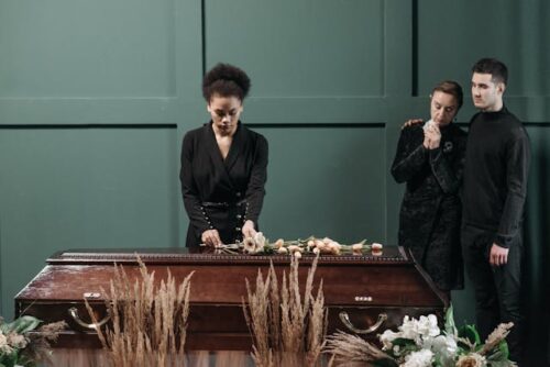 family gathered around loved one's coffin